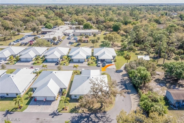 aerial view featuring a residential view and a wooded view