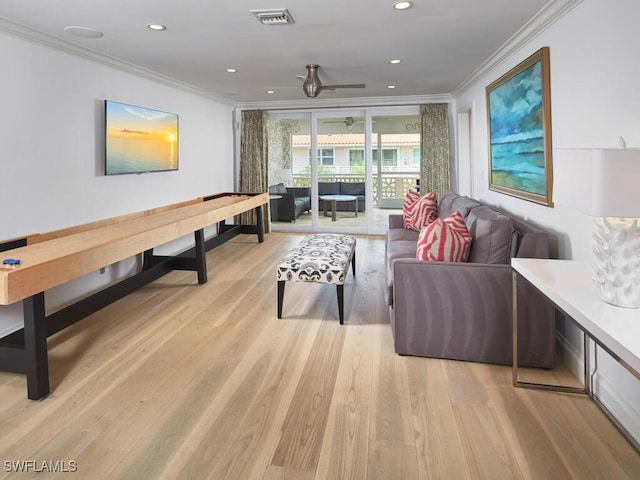 living room with light wood-style floors, recessed lighting, visible vents, and crown molding