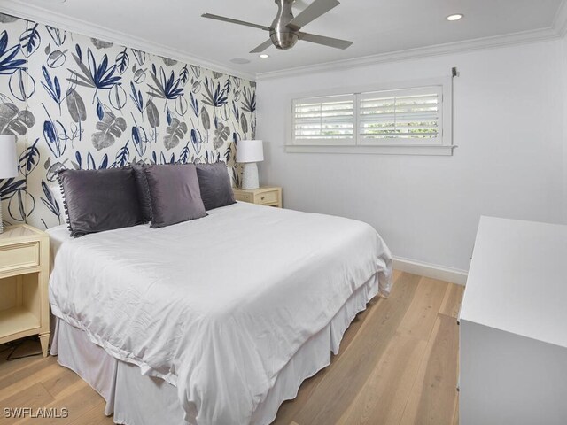 bedroom with crown molding, baseboards, and wood finished floors