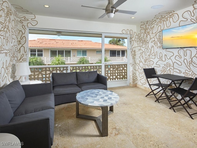 sunroom with ceiling fan and a wealth of natural light