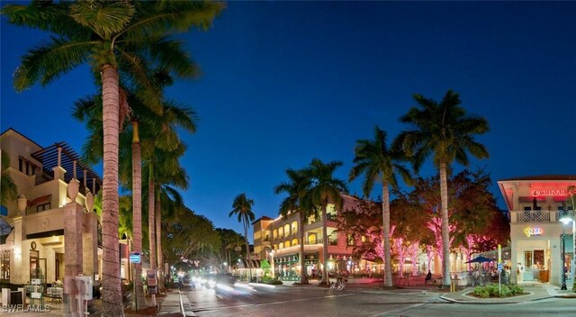 view of street with sidewalks, street lights, and curbs