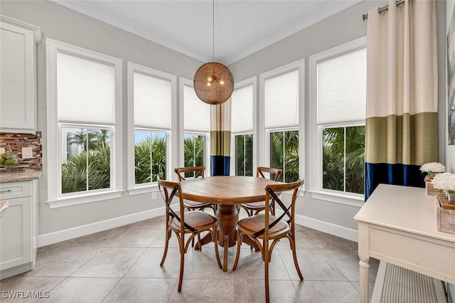 dining area featuring light tile patterned floors, plenty of natural light, and baseboards