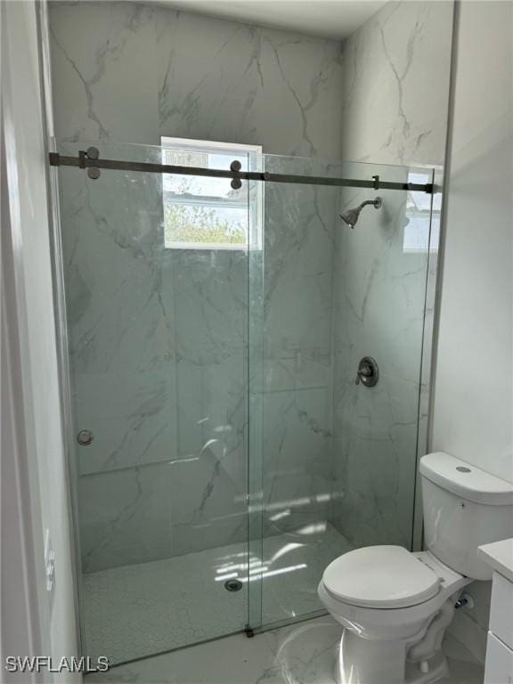 full bathroom with a marble finish shower, marble finish floor, toilet, and vanity