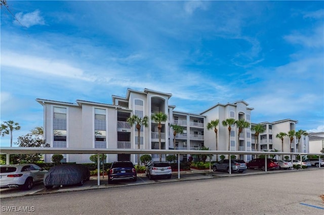 view of building exterior featuring covered parking