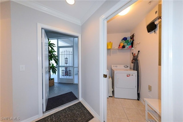 laundry area with laundry area, baseboards, washer and clothes dryer, crown molding, and light tile patterned flooring