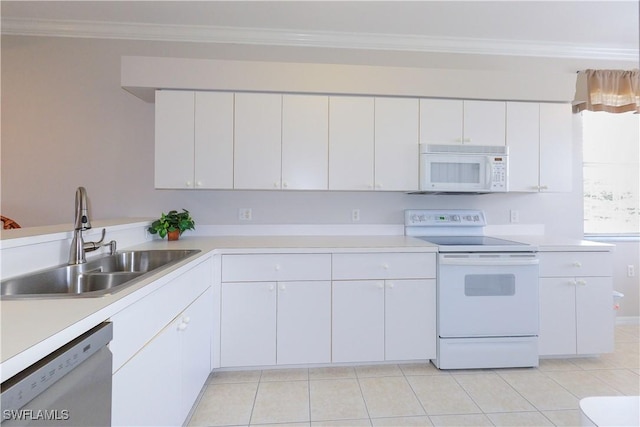 kitchen featuring white appliances, a sink, white cabinets, and crown molding