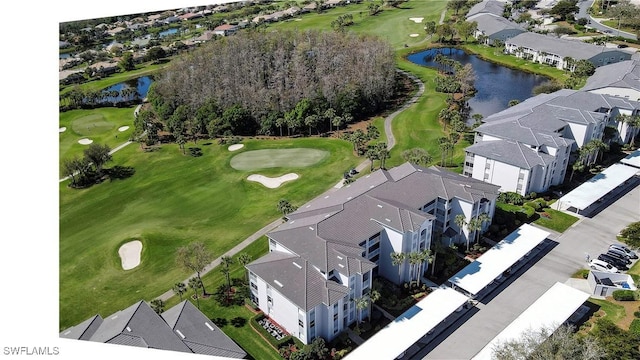 aerial view with view of golf course, a water view, and a residential view