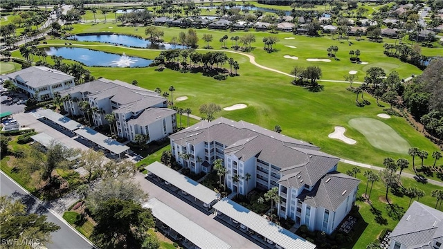 birds eye view of property with a residential view, view of golf course, and a water view