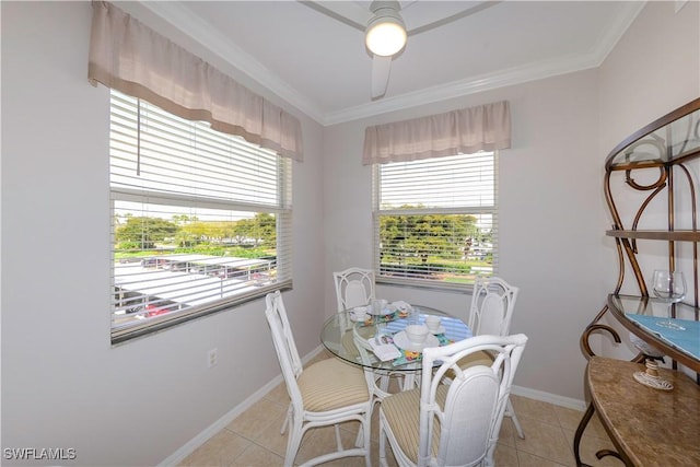 dining area featuring crown molding, baseboards, and light tile patterned floors