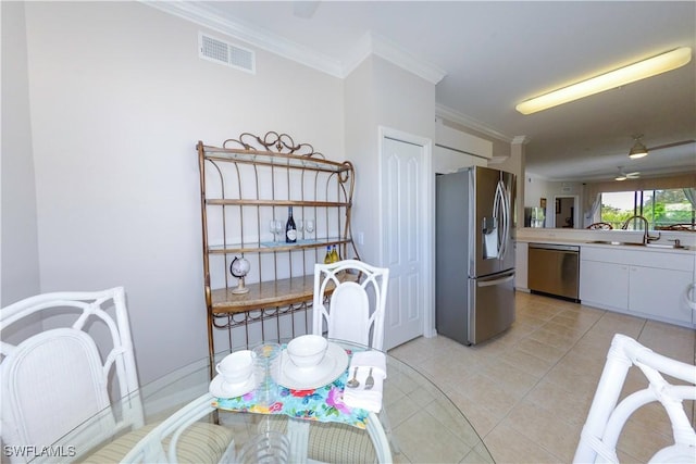 kitchen with visible vents, appliances with stainless steel finishes, ornamental molding, light tile patterned flooring, and a sink