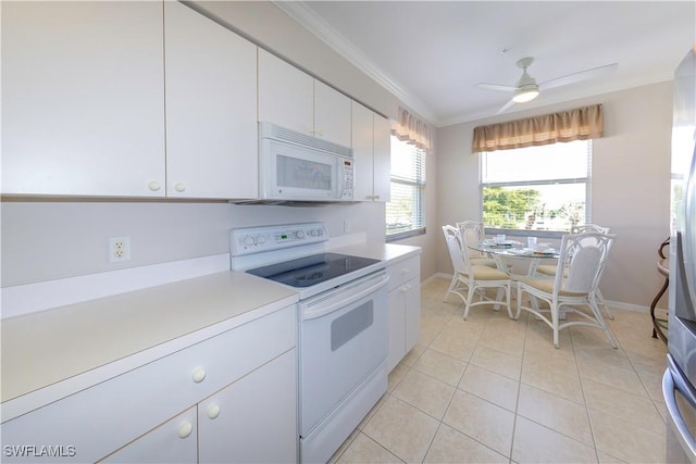 kitchen featuring crown molding, light countertops, light tile patterned flooring, white cabinets, and white appliances