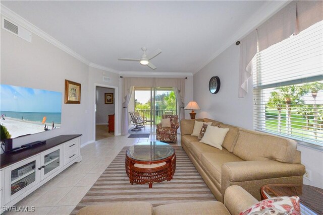 living room featuring light tile patterned floors, ceiling fan, visible vents, and crown molding