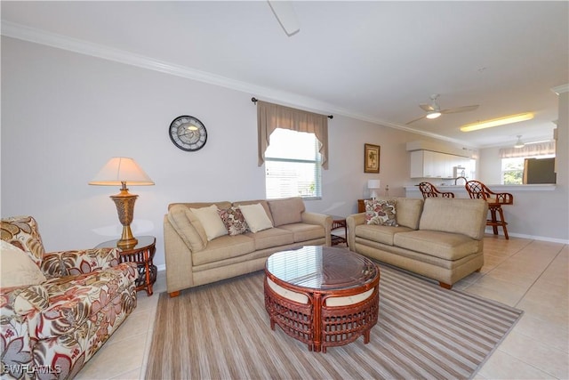 living area featuring light tile patterned floors, a wealth of natural light, and crown molding