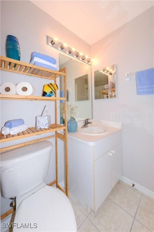 bathroom featuring toilet, vanity, and tile patterned floors