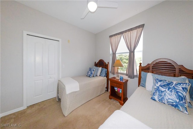 bedroom featuring a ceiling fan and light colored carpet