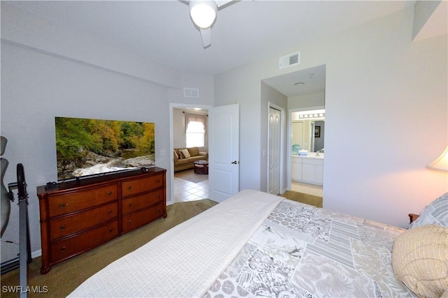 bedroom with a ceiling fan, visible vents, and ensuite bathroom