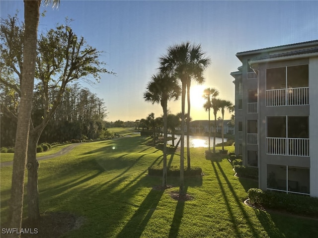 view of property's community featuring a water view and a yard