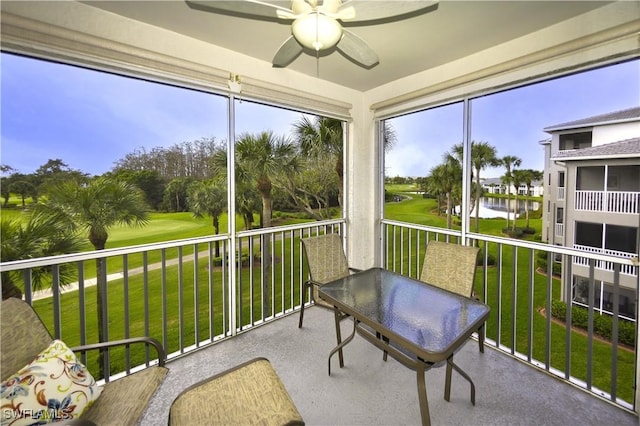 sunroom / solarium featuring ceiling fan