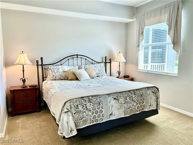 bedroom featuring carpet and baseboards