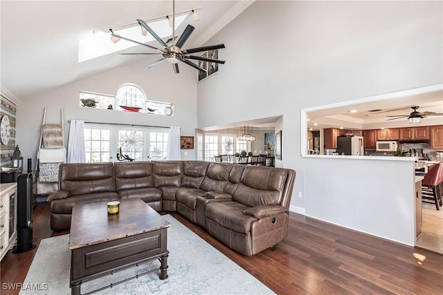 living room with lofted ceiling, a ceiling fan, and wood finished floors