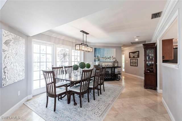 dining space with a healthy amount of sunlight, visible vents, crown molding, and baseboards