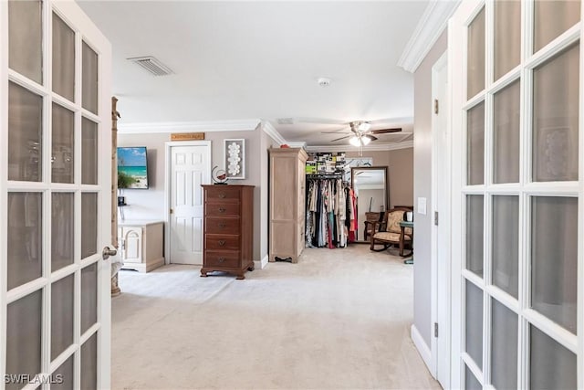 corridor featuring ornamental molding, light colored carpet, french doors, and visible vents