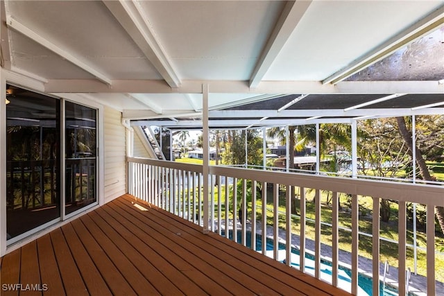 wooden terrace featuring glass enclosure and an outdoor pool