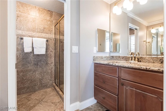 bathroom featuring ornamental molding, baseboards, a shower stall, and vanity