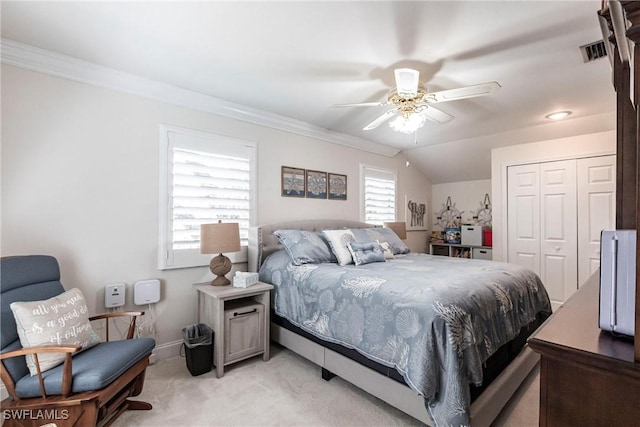 bedroom featuring ornamental molding, a closet, visible vents, and light colored carpet