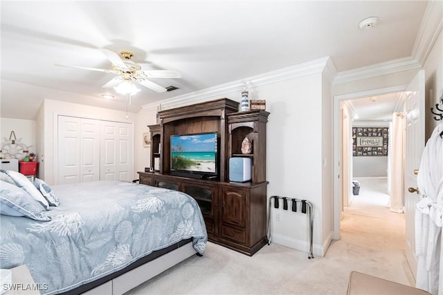 bedroom with light carpet, baseboards, ceiling fan, crown molding, and a closet