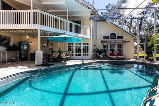 pool featuring ceiling fan, french doors, a patio area, and a lanai