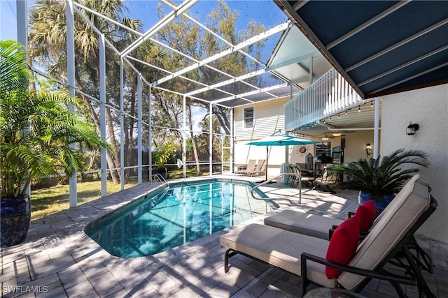 outdoor pool featuring a patio area and glass enclosure