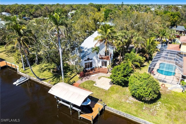 drone / aerial view with a water view and a view of trees