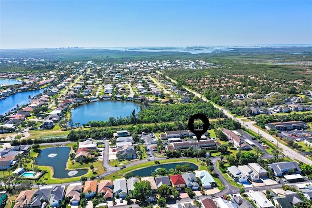 birds eye view of property featuring a water view and a residential view