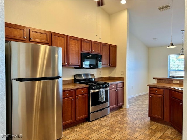 kitchen with baseboards, visible vents, dark countertops, hanging light fixtures, and stainless steel appliances