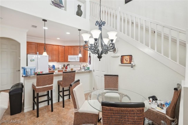 dining space with light tile patterned floors, visible vents, an inviting chandelier, crown molding, and recessed lighting