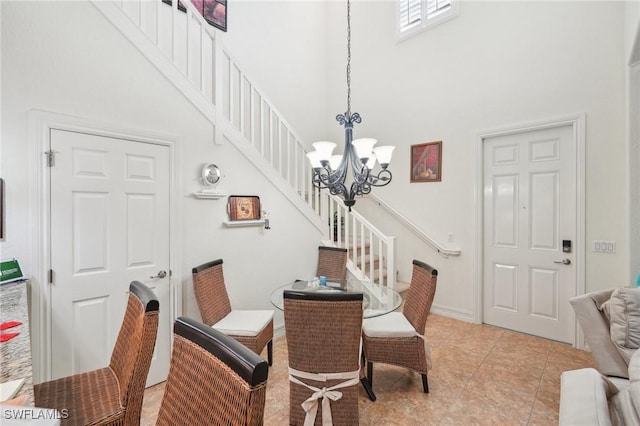 dining space with an inviting chandelier, a high ceiling, stairway, and light tile patterned flooring