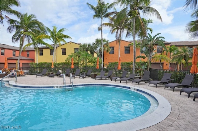 pool with fence and a patio