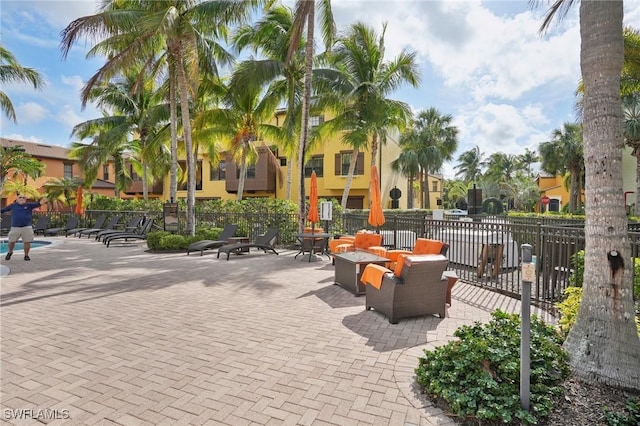 view of property's community featuring a patio area and fence