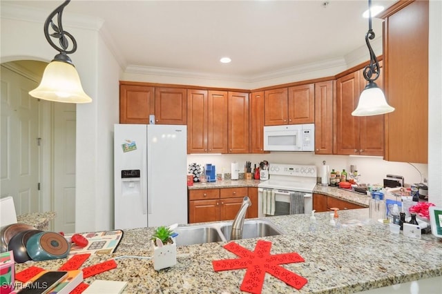 kitchen with hanging light fixtures, white appliances, ornamental molding, and a sink