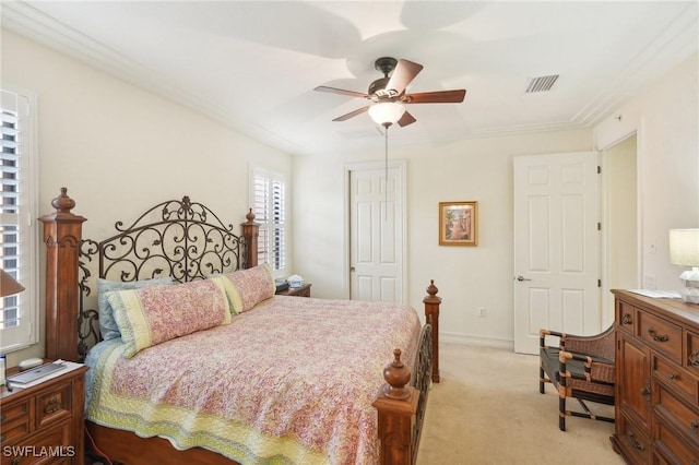 bedroom featuring ceiling fan, light colored carpet, visible vents, baseboards, and a closet