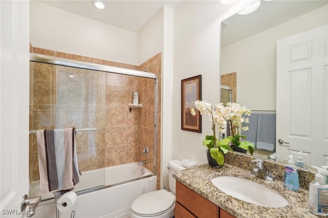 full bath with toilet, combined bath / shower with glass door, and vanity