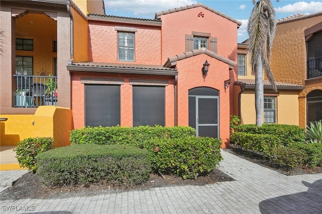 view of front of house with stucco siding and a tiled roof