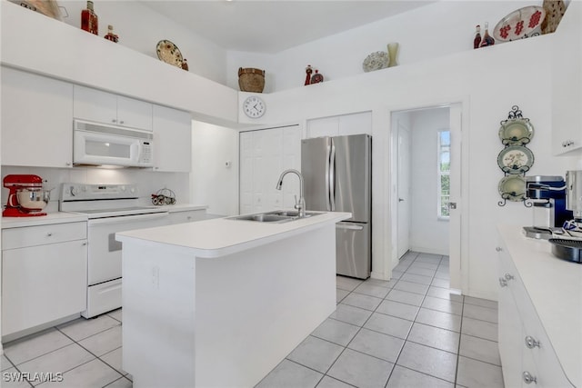 3650 Sunland Ln, Estero, FL 33928 - kitchen with white appliances, light countertops, light tile patterned flooring, and white cabinetry