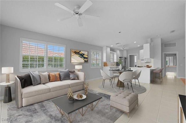 living area with light tile patterned floors, recessed lighting, visible vents, and a ceiling fan