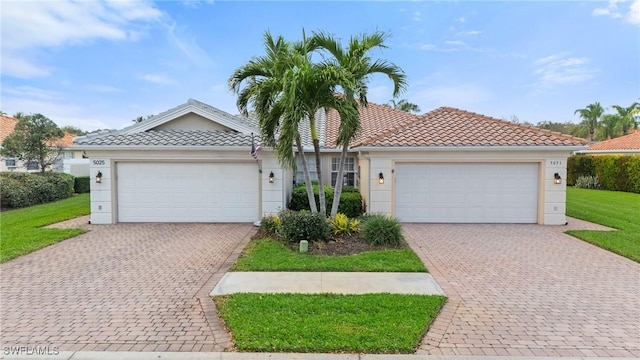 ranch-style house with a garage, a front yard, decorative driveway, and a tiled roof