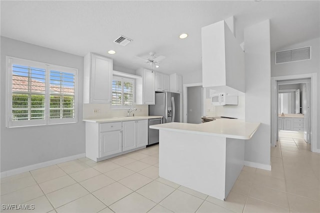 kitchen featuring visible vents, stainless steel appliances, and light countertops