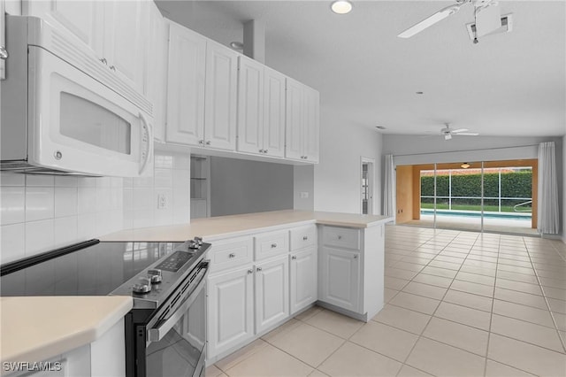 kitchen featuring light countertops, ceiling fan, electric range oven, and white microwave