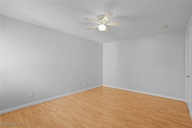 empty room with light wood-style flooring, baseboards, and ceiling fan