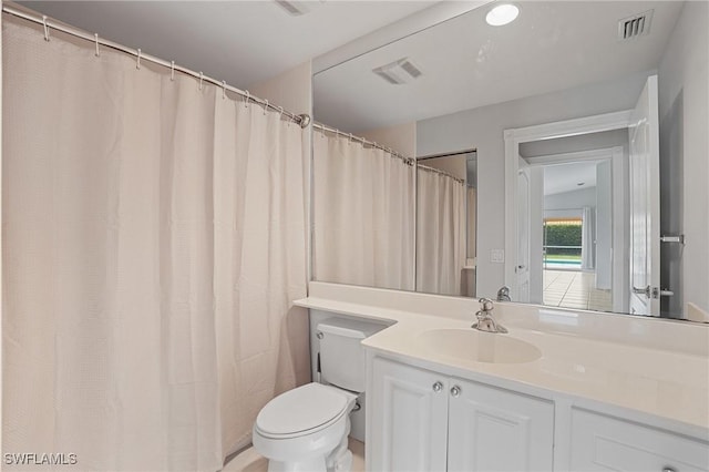 full bath with toilet, vanity, and visible vents